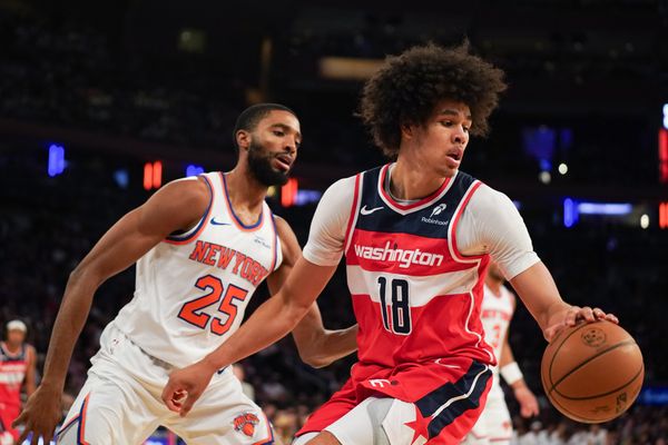 Nov 3, 2025; New York, New York, USA; Washington forward Kyshawn George (18) is defended by New York Knicks guard Mikal Bridges (25) during the second half at Madison Square Garden. Mandatory Credit: Lucas Boland-Imagn Images