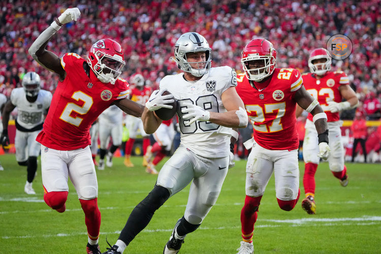 Nov 29, 2024; Kansas City, Missouri, USA; Las Vegas Raiders tight end Brock Bowers (89) scores a touchdown as Kansas City Chiefs cornerback Joshua Williams (2) and safety Chamarri Conner (27) chase during the second half at GEHA Field at Arrowhead Stadium. Credit: Denny Medley-Imagn Images