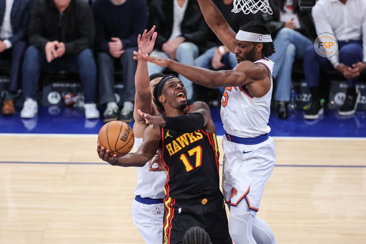 Feb 12, 2025; New York, New York, USA;  Atlanta Hawks forward Onyeka Okongwu (17) looks to drive past New York Knicks forward Precious Achiuwa (5) in overtime at Madison Square Garden. Credit: Wendell Cruz-Imagn Images