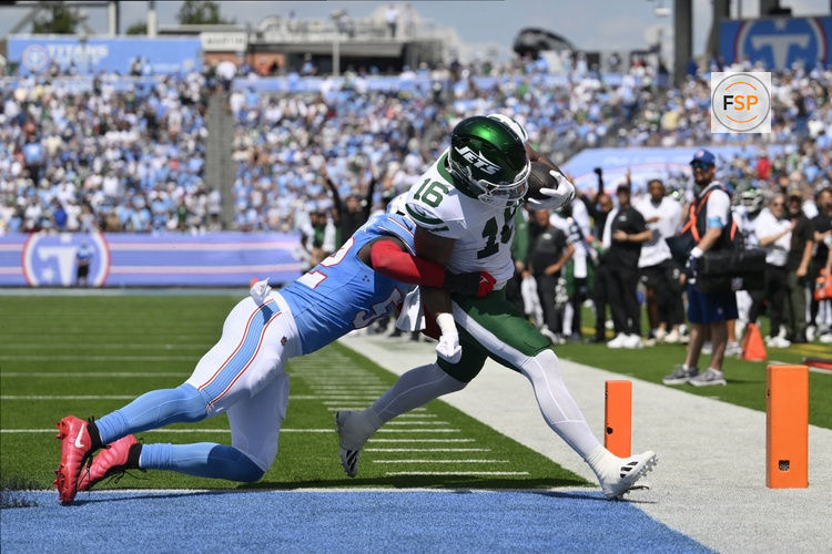 Sep 13, 2026; Nashville, Tennessee, USA;  New York Jets tight end Kenyon Sadiq (16) scores a touchdown after a catch against the Tennessee Titans linebacker James Williams Sr. (52) during the first quarter at Nissan Stadium.  Credit: Steve Roberts-Imagn Images
