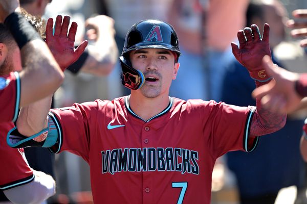 Aug 31, 2025; Los Angeles, California, USA;  Arizona Diamondbacks left fielder Corbin Carroll (7) celebrates in the dugout after hitting a three-run home run during the eighth inning off Los Angeles Dodgers relief pitcher Tanner Scott (66) at Dodger Stadium. Mandatory Credit: Jayne Kamin-Oncea-Imagn Images
