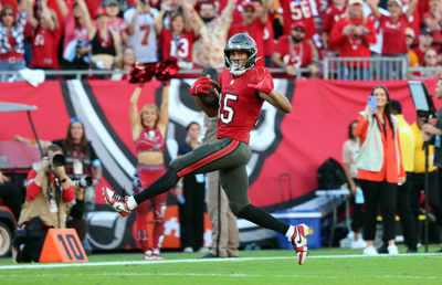 Dec 8, 2024; Tampa, Florida, USA; Tampa Bay Buccaneers wide receiver Jalen McMillan (15) runs the ball in for a touchdown  against the Las Vegas Raiders during the second half at Raymond James Stadium. Mandatory Credit: Kim Klement Neitzel-Imagn Images