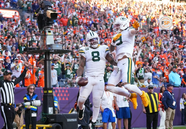Dec 14, 2025; Denver, Colorado, USA; Green Bay Packers running back Josh Jacobs (8) and wide receiver Christian Watson (9) react after a touchdown during the second quarter against the Denver Broncos at Empower Field at Mile High. Credit: Ron Chenoy-Imagn Images