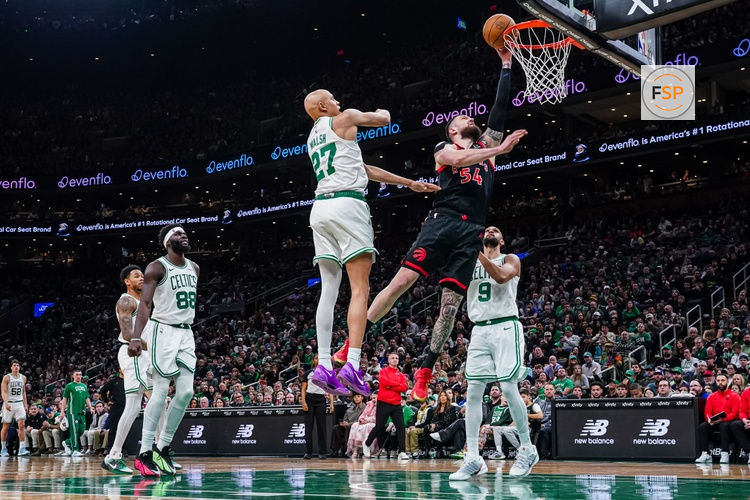 Jan 9, 2026; Boston, Massachusetts, USA; Toronto Raptors forward Sandro Mamukelashvili (54) shoots the ball  against Boston Celtics guard Jordan Walsh (27) and guard Derrick White (9) in the second half at TD Garden. Credit: David Butler II-Imagn Images