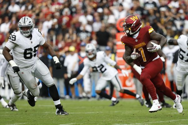Sep 21, 2025; Landover, Maryland, USA; Washington Commanders wide receiver Deebo Samuel Sr. (1) runs with the ball as Las Vegas Raiders defensive tackle Adam Butler (69) chases during the third quarter at Northwest Stadium. Mandatory Credit: Geoff Burke-Imagn Images
