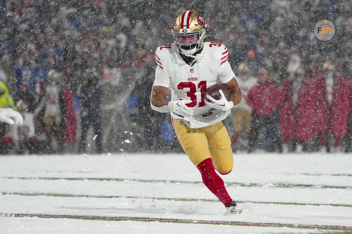 Dec 1, 2024; Orchard Park, New York, USA; San Francisco 49ers running back Isaac Guerendo (31) runs with the ball for a touchdown against the Buffalo Bills during the second half at Highmark Stadium. Credit: Gregory Fisher-Imagn Images