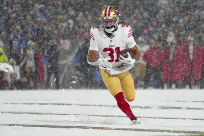 Dec 1, 2024; Orchard Park, New York, USA; San Francisco 49ers running back Isaac Guerendo (31) runs with the ball for a touchdown against the Buffalo Bills during the second half at Highmark Stadium. Mandatory Credit: Gregory Fisher-Imagn Images