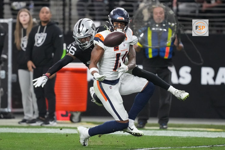 Dec 7, 2025; Paradise, Nevada, USA;  Las Vegas Raiders cornerback Darien Porter (26) breaks up the pass to Denver Broncos wide receiver Courtland Sutton (14) during the second half at Allegiant Stadium. Credit: Kirby Lee-Imagn Images