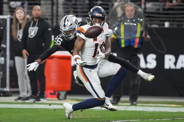 Dec 7, 2025; Paradise, Nevada, USA;  Las Vegas Raiders cornerback Darien Porter (26) breaks up the pass to Denver Broncos wide receiver Courtland Sutton (14) during the second half at Allegiant Stadium. Mandatory Credit: Kirby Lee-Imagn Images