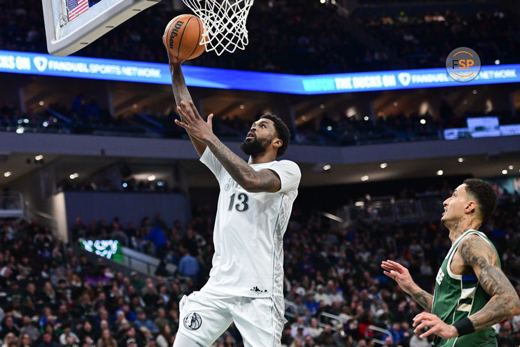 Mar 5, 2025; Milwaukee, Wisconsin, USA; Dallas Mavericks forward Naji Marshall (13) takes a shot against Milwaukee Bucks forward Kyle Kuzma (18) in the third quarter at Fiserv Forum. Credit: Benny Sieu-Imagn Images