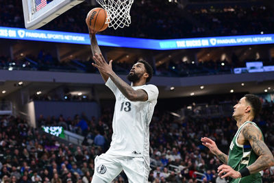 Mar 5, 2025; Milwaukee, Wisconsin, USA; Dallas Mavericks forward Naji Marshall (13) takes a shot against Milwaukee Bucks forward Kyle Kuzma (18) in the third quarter at Fiserv Forum. Mandatory Credit: Benny Sieu-Imagn Images