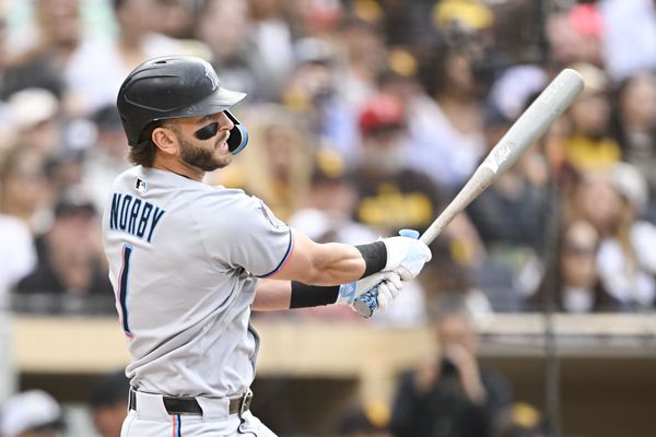 May 26, 2025; San Diego, California, USA; Miami Marlins third baseman Connor Norby (1) hits an RBI single during the first inning against the San Diego Padres at Petco Park. Mandatory Credit: Denis Poroy-Imagn Images