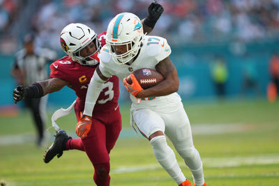 Oct 27, 2024; Miami Gardens, Florida, USA; Miami Dolphins wide receiver Jaylen Waddle (17) catches a pass in the fourth quarter as Arizona Cardinals safety Budda Baker (3) closes in on the play at Hard Rock Stadium. Mandatory Credit: Jim Rassol-Imagn Images