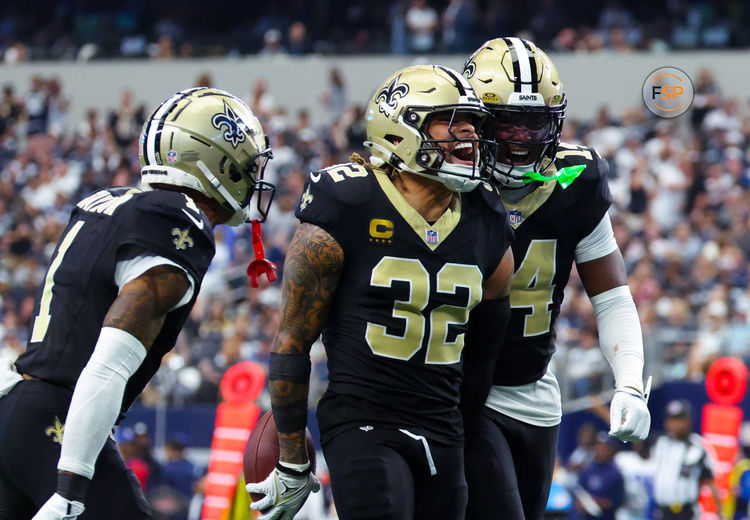 Sep 15, 2024; Arlington, Texas, USA; New Orleans Saints safety Tyrann Mathieu (32) celebrates with New Orleans Saints cornerback Alontae Taylor (1) and New Orleans Saints cornerback Kool-Aid McInstry(14) after making an interception during the second half against the Dallas Cowboys at AT&T Stadium. Credit: Kevin Jairaj-Imagn Images