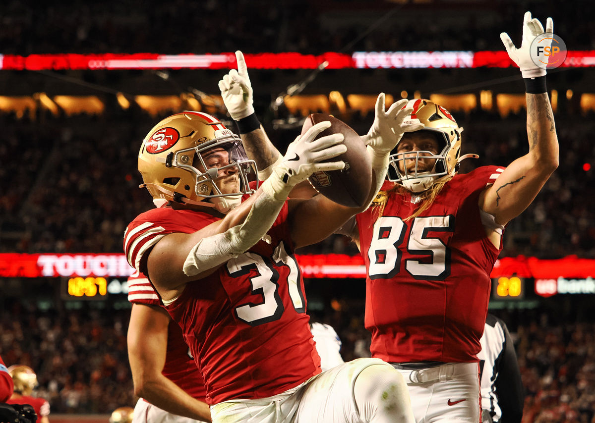 Oct 27, 2024; Santa Clara, California, USA; San Francisco 49ers running back Isaac Guerendo (31) celebrates with San Francisco 49ers tight end George Kittle (85) after scoring a touchdown against the Dallas Cowboys during the third quarter at Levi's Stadium. Credit: Kelley L Cox-Imagn Images