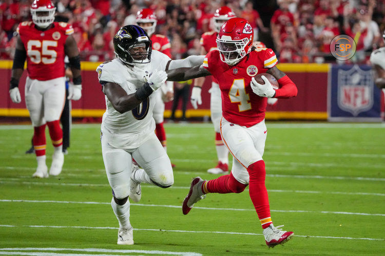 Sep 5, 2024; Kansas City, Missouri, USA; Kansas City Chiefs wide receiver Rashee Rice (4) runs the ball as Baltimore Ravens linebacker Roquan Smith (0) defends during the first half at GEHA Field at Arrowhead Stadium. Credit: Denny Medley-Imagn Images