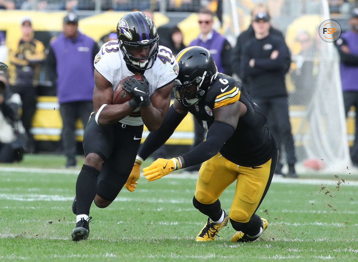 Nov 17, 2024; Pittsburgh, Pennsylvania, USA;  Baltimore Ravens running back Justice Hill (43) runs the ball against Pittsburgh Steelers linebacker Patrick Queen (6) during the third quarter at Acrisure Stadium. Credit: Charles LeClaire-Imagn Images