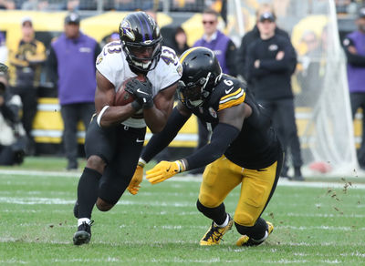 Nov 17, 2024; Pittsburgh, Pennsylvania, USA;  Baltimore Ravens running back Justice Hill (43) runs the ball against Pittsburgh Steelers linebacker Patrick Queen (6) during the third quarter at Acrisure Stadium. Mandatory Credit: Charles LeClaire-Imagn Images