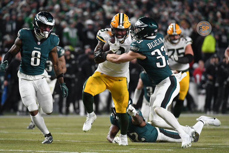 Jan 12, 2025; Philadelphia, Pennsylvania, USA; Green Bay Packers running back Josh Jacobs (8) rushes the ball against Philadelphia Eagles cornerback Cooper DeJean (33) during the second half in an NFC wild card game at Lincoln Financial Field. Credit: Eric Hartline-Imagn Images