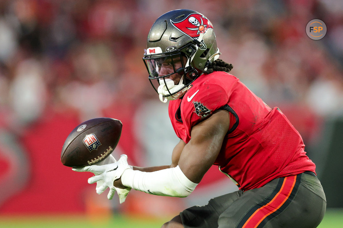 Dec 24, 2023; Tampa, Florida, USA;  Tampa Bay Buccaneers running back Rachaad White (1) bobbles a pass against the Jacksonville Jaguars in the third quarter at Raymond James Stadium. Credit: Nathan Ray Seebeck-USA TODAY Sports