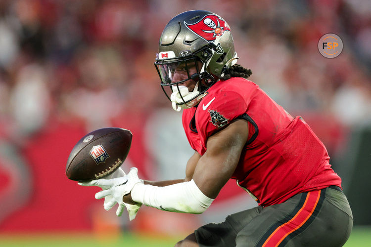 Dec 24, 2023; Tampa, Florida, USA;  Tampa Bay Buccaneers running back Rachaad White (1) bobbles a pass against the Jacksonville Jaguars in the third quarter at Raymond James Stadium. Credit: Nathan Ray Seebeck-USA TODAY Sports