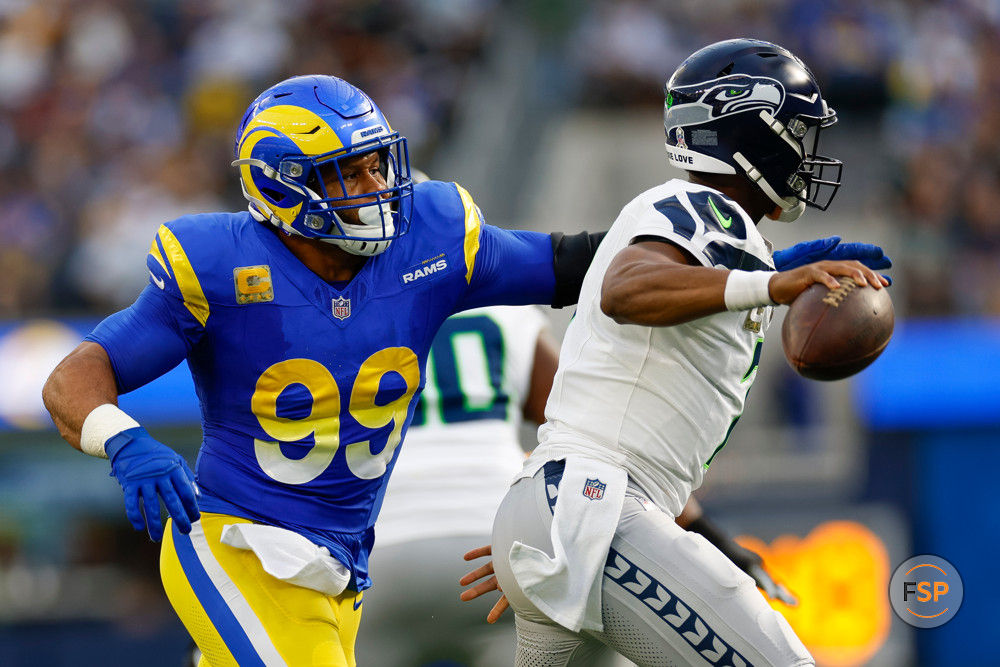 INGLEWOOD, CA - NOVEMBER 19: Los Angeles Rams defensive tackle Aaron Donald (99) pressures Seattle Seahawks quarterback Geno Smith (7) in the first quarter during an NFL regular season game on November 19, 2023, at SoFi Stadium in Inglewood, CA. (Photo by Brandon Sloter/Icon Sportswire)