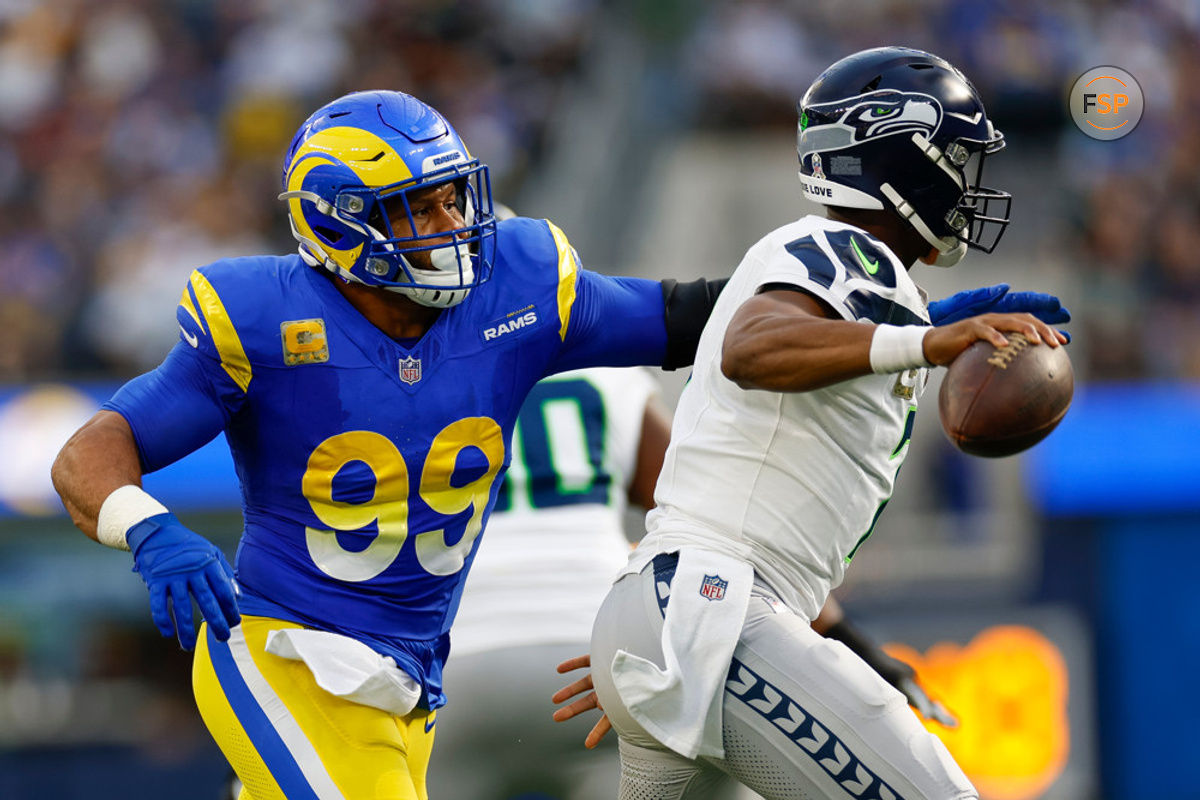 INGLEWOOD, CA - NOVEMBER 19: Los Angeles Rams defensive tackle Aaron Donald (99) pressures Seattle Seahawks quarterback Geno Smith (7) in the first quarter during an NFL regular season game on November 19, 2023, at SoFi Stadium in Inglewood, CA. (Photo by Brandon Sloter/Icon Sportswire)