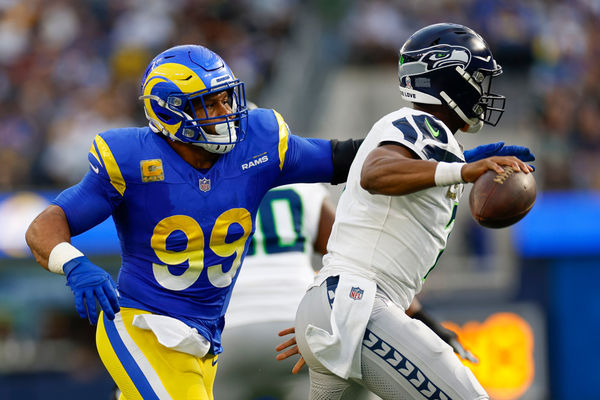 INGLEWOOD, CA - NOVEMBER 19: Los Angeles Rams defensive tackle Aaron Donald (99) pressures Seattle Seahawks quarterback Geno Smith (7) in the first quarter during an NFL regular season game on November 19, 2023, at SoFi Stadium in Inglewood, CA. (Photo by Brandon Sloter/Icon Sportswire)