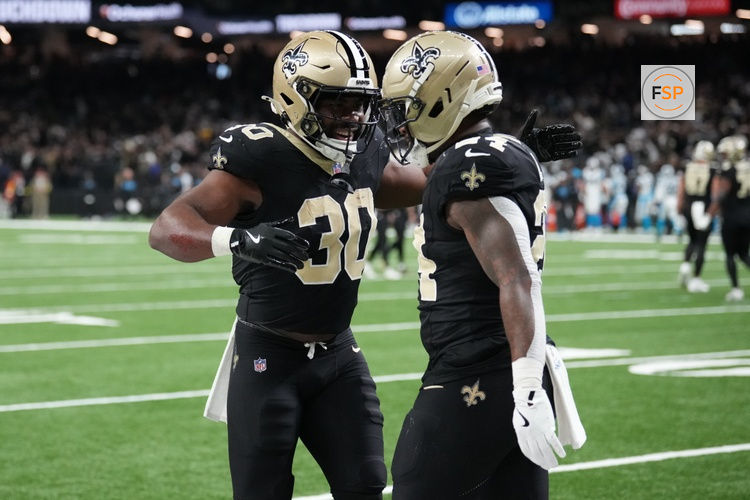 Dec 14, 2025; New Orleans, Louisiana, USA; New Orleans Saints running back Devin Neal (24) celebrates with running back Audric Estime (30) after scoring a touchdown during the second quarter against the Carolina Panthers at Caesars Superdome. Credit: Matthew Hinton-Imagn Images