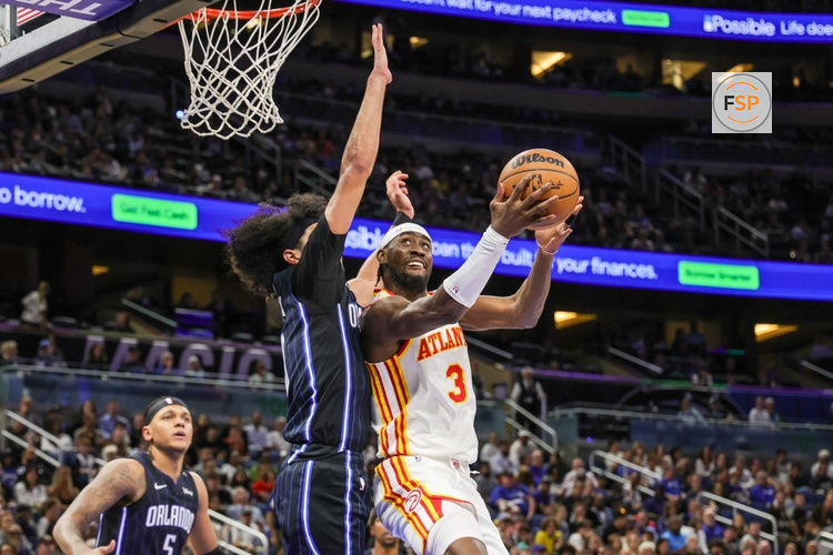 Apr 8, 2025; Orlando, Florida, USA; Atlanta Hawks guard Caris LeVert (3) goes to the basket against Orlando Magic guard Anthony Black (0) during the second quarter at Kia Center. Credit: Mike Watters-Imagn Images