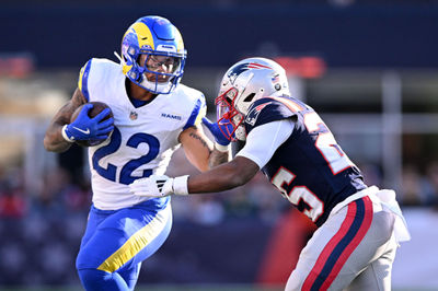 Nov 17, 2024; Foxborough, Massachusetts, USA; Los Angeles Rams running back Blake Corum (22) runs with the ball against New England Patriots cornerback Marcus Jones (25) during the first half at Gillette Stadium. Mandatory Credit: Brian Fluharty-Imagn Images