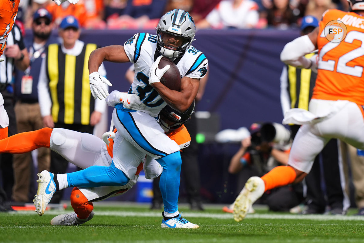 Oct 27, 2024; Denver, Colorado, USA; Carolina Panthers running back Chuba Hubbard (30) carries the ball in the first quarter against the Denver Broncos at Empower Field at Mile High. Credit: Ron Chenoy-Imagn Images