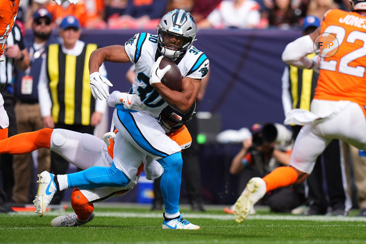 Oct 27, 2024; Denver, Colorado, USA; Carolina Panthers running back Chuba Hubbard (30) carries the ball in the first quarter against the Denver Broncos at Empower Field at Mile High. Credit: Ron Chenoy-Imagn Images