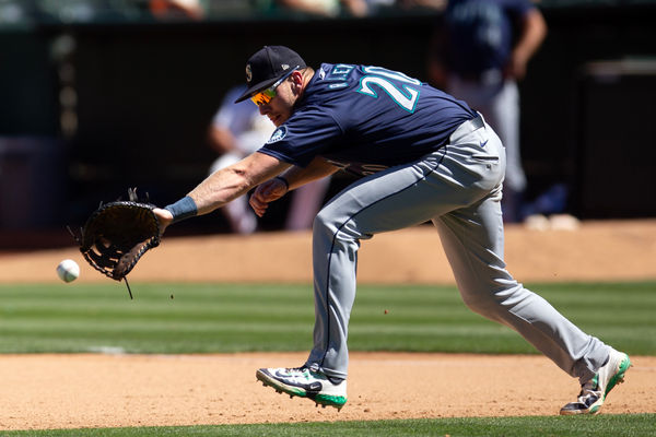 Sep 5, 2024; Oakland, California, USA; Seattle Mariners first baseman Luke Raley (20) attempts to field a ball hit by Oakland Athletics right fielder Lawrence Butler (not pictured) during the seventh inning at Oakland-Alameda County Coliseum. Mandatory Credit: D. Ross Cameron-Imagn Images