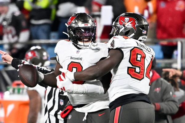 Dec 1, 2024; Charlotte, North Carolina, USA; Tampa Bay Buccaneers linebacker Yaya Diaby (0) celebrates with defensive tackle Calijah Kancey (94) after recovering a fumble in overtime in overtime at Bank of America Stadium. Mandatory Credit: Bob Donnan-Imagn Images