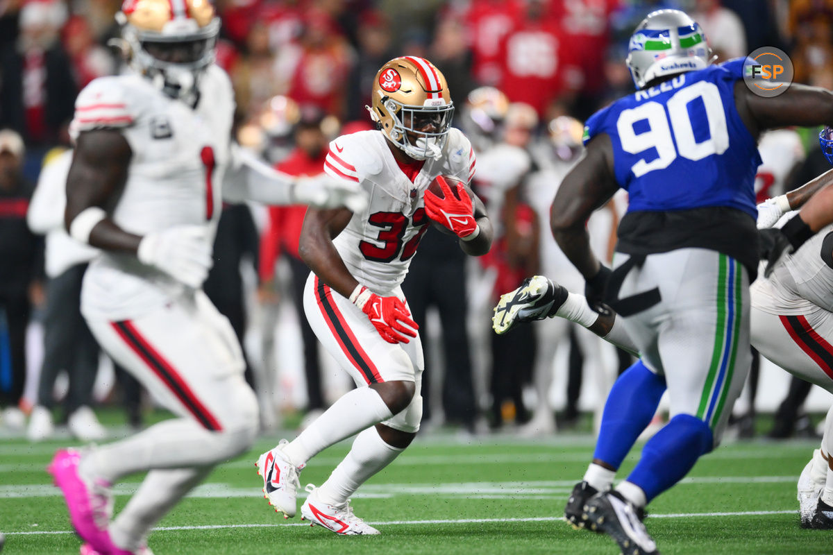 Oct 10, 2024; Seattle, Washington, USA; San Francisco 49ers running back Patrick Taylor Jr. (32) carries the ball against the Seattle Seahawks during the second half at Lumen Field. Credit: Steven Bisig-Imagn Images