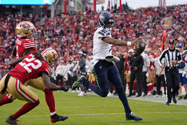 Nov 17, 2024; Santa Clara, California, USA; Seattle Seahawks quarterback Geno Smith (7) scores a rushing touchdown past San Francisco 49ers cornerback Isaac Yiadom (22) to win the game in the fourth quarter at Levi's Stadium. Credit: David Gonzales-Imagn Images