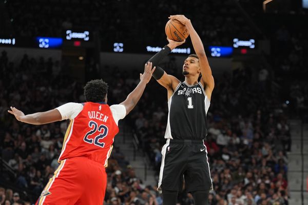 Nov 8, 2025; San Antonio, Texas, USA;  San Antonio Spurs forward Victor Wembanyama (1) shoots over New Orleans Pelicans center Derik Queen (22) in the second half at Frost Bank Center. Mandatory Credit: Daniel Dunn-Imagn Images