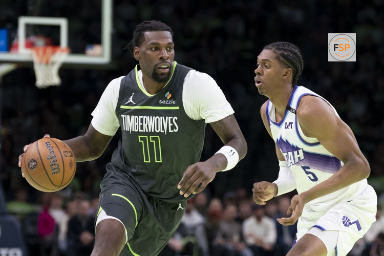 Nov 7, 2025; Minneapolis, Minnesota, USA; Minnesota Timberwolves center Naz Reid (11) dribbles the ball past Utah Jazz forward Cody Williams (5) in the second half at Target Center. Credit: Jesse Johnson-Imagn Images