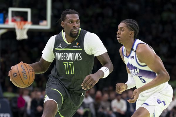 Nov 7, 2025; Minneapolis, Minnesota, USA; Minnesota Timberwolves center Naz Reid (11) dribbles the ball past Utah Jazz forward Cody Williams (5) in the second half at Target Center. Mandatory Credit: Jesse Johnson-Imagn Images
