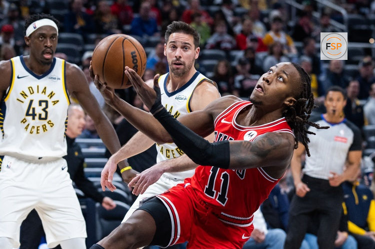 Jan 28, 2026; Indianapolis, Indiana, USA;  Chicago Bulls guard Ayo Dosunmu (11) shoots the ball while Indiana Pacers guard T.J. McConnell (9) defends in the first half at Gainbridge Fieldhouse. Credit: Trevor Ruszkowski-Imagn Images