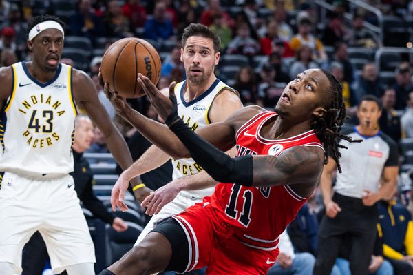 Jan 28, 2026; Indianapolis, Indiana, USA;  Chicago Bulls guard Ayo Dosunmu (11) shoots the ball while Indiana Pacers guard T.J. McConnell (9) defends in the first half at Gainbridge Fieldhouse. Mandatory Credit: Trevor Ruszkowski-Imagn Images