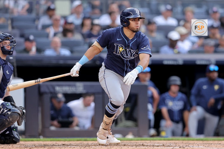 Jul 31, 2025; Bronx, New York, USA; Tampa Bay Rays first baseman Jonathan Aranda (62) follows through on an RBI single against the New York Yankees during the fourth inning at Yankee Stadium. Credit: Brad Penner-Imagn Images
