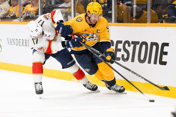 Feb 25, 2025; Nashville, Tennessee, USA;  Nashville Predators defenseman Roman Josi (59) and Florida Panthers center Evan Rodrigues (17) battle for the puck during the second period at Bridgestone Arena. Mandatory Credit: Steve Roberts-Imagn Images