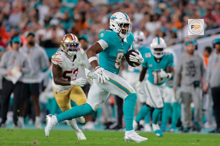 Dec 22, 2024; Miami Gardens, Florida, USA; Miami Dolphins tight end Jonnu Smith (9) runs with the football against the San Francisco 49ers during the third quarter at Hard Rock Stadium. Credit: Sam Navarro-Imagn Images