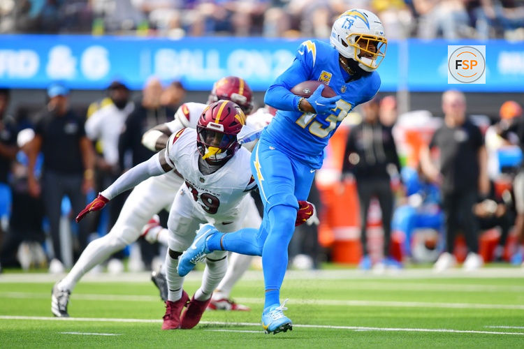 Oct 5, 2025; Inglewood, California, USA; Los Angeles Chargers wide receiver Keenan Allen (13) runs against Washington Commanders safety Jeremy Reaves (39) in the first half  at SoFi Stadium. Credit: Gary A. Vasquez-Imagn Images