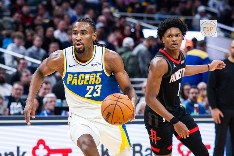Feb 2, 2026; Indianapolis, Indiana, USA; Indiana Pacers guard/forward Aaron Nesmith (23) dribbles the ball while Houston Rockets guard/forward Amen Thompson (1) defends in the second half at Gainbridge Fieldhouse. Credit: Trevor Ruszkowski-Imagn Images
