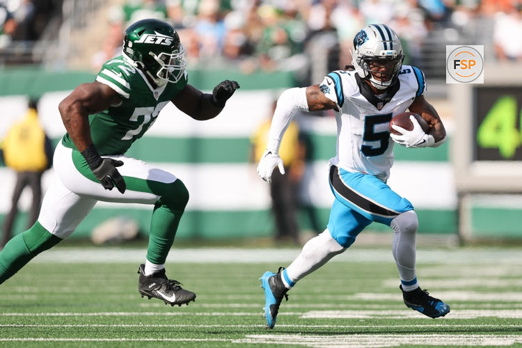 Oct 19, 2025; East Rutherford, New Jersey, USA; Carolina Panthers running back Rico Dowdle (5) runs with the ball while being defended by New York Jets defensive lineman Micheal Clemons (72) in the third quarter at MetLife Stadium. Credit: Vincent Carchietta-Imagn Images
