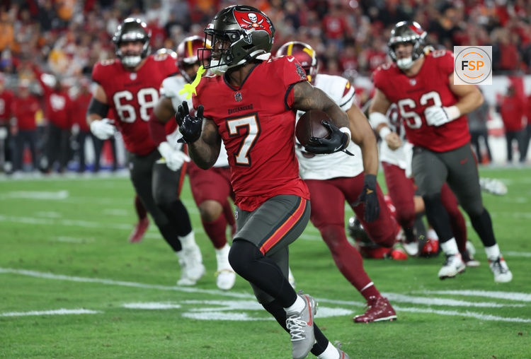 Jan 12, 2025; Tampa, Florida, USA; Tampa Bay Buccaneers running back Bucky Irving (7) runs during the third quarter of a NFC wild card playoff against the Washington Commanders at Raymond James Stadium. Credit: Kim Klement Neitzel-Imagn Images