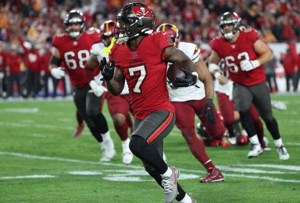 Jan 12, 2025; Tampa, Florida, USA; Tampa Bay Buccaneers running back Bucky Irving (7) runs during the third quarter of a NFC wild card playoff against the Washington Commanders at Raymond James Stadium. Mandatory Credit: Kim Klement Neitzel-Imagn Images
